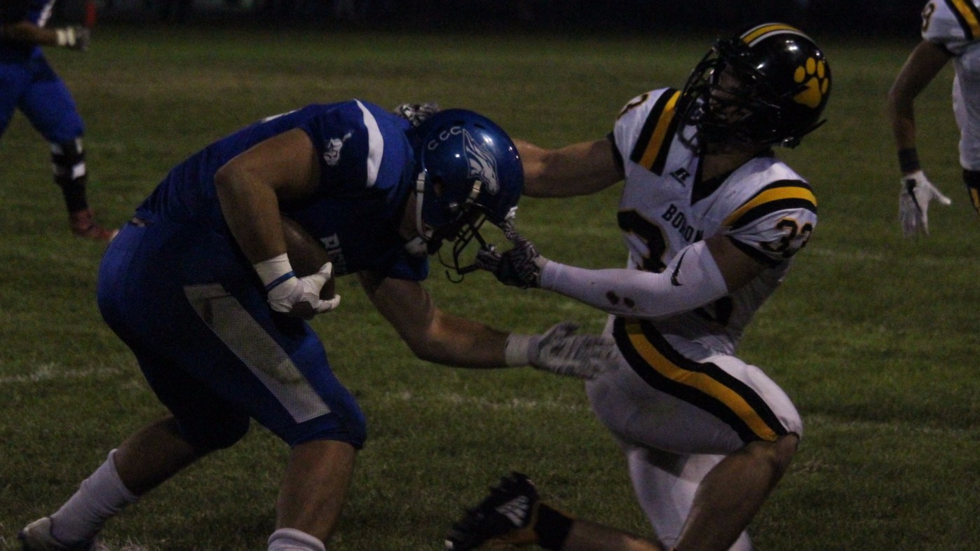 Mike Molina getting his helmet ripped off by Bobcat defender. 