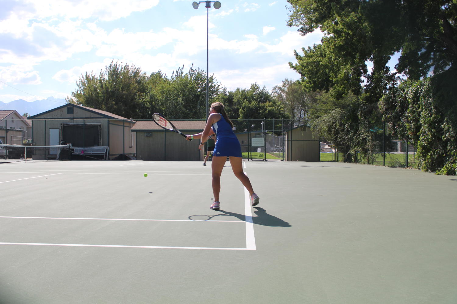 Tami Lee playing a challenging tennis match at the Bishop City Park