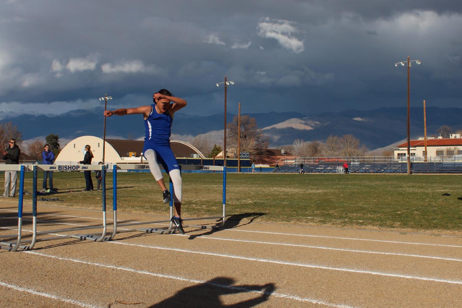 Jon Tait, a junior, completes the boys' 300 meter hurdles, marking the beginning of his hurdling career