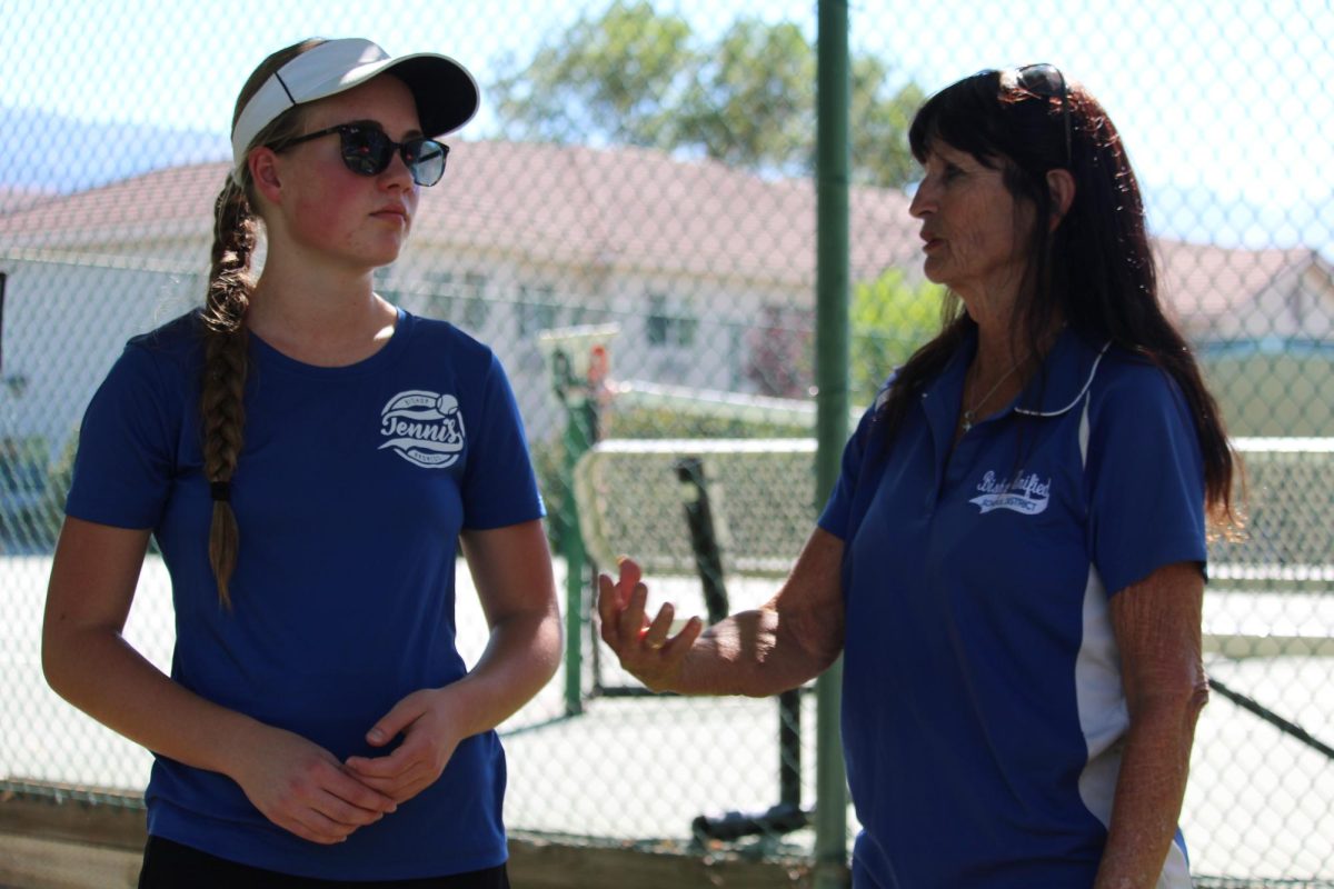 Sydney Norcross and Patty Cummings having a convo about tennis